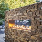 Outdoor Greatroom ready-to-finish see-thru gas fireplace. Custom stone and installation