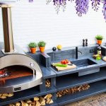 A custom outdoor kitchen with an Alfa wood fired pizza oven