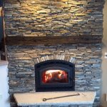Astria Montecito wood fireplace with Cinnamon Bark ledgestone