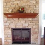 Stone fireplace with mantel, design installation by La Crosse Fireplace