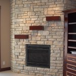 Stone fireplace with custom mantel, design installation by La Crosse Fireplace