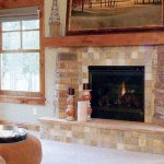 Rustic stone fireplace with wood mantel, installation by La Crosse Fireplace