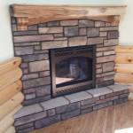 Corner stone fireplace with mantel, design installation by La Crosse Fireplace