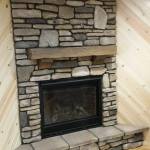 Stone fireplace for corner with mantel, design installation by La Crosse Fireplace