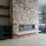 Traditional stone fireplace installation