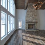Farmhouse stone fireplace with mantel, design installation by La Crosse Fireplace