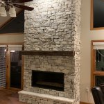 Kozy Heat Slayton 42 Gas Fireplace with Realstone Systems Berkshire Buff stone and barn beam style mantel