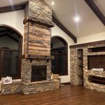 Wood fireplace with stone and barn beam mantel