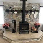 Wood stove with raised hearth and stone wall