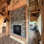 Teton Shadow rock with see-thru gas fireplace and barn beam hearth