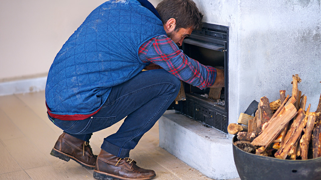 guy fixing fireplace